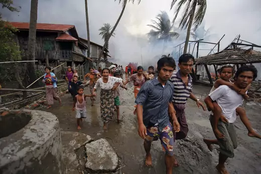 Rohingya run from a fire set in Sittwe, June 10, 2012.