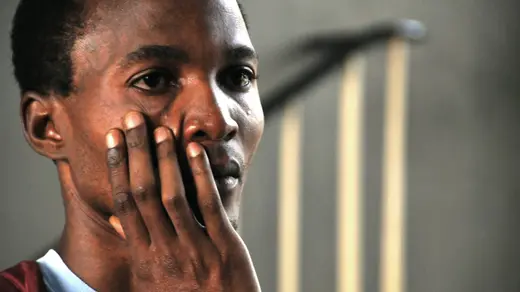 A Ugandan man waits to learn the fate of victims of the bomb blasts in Kampala.